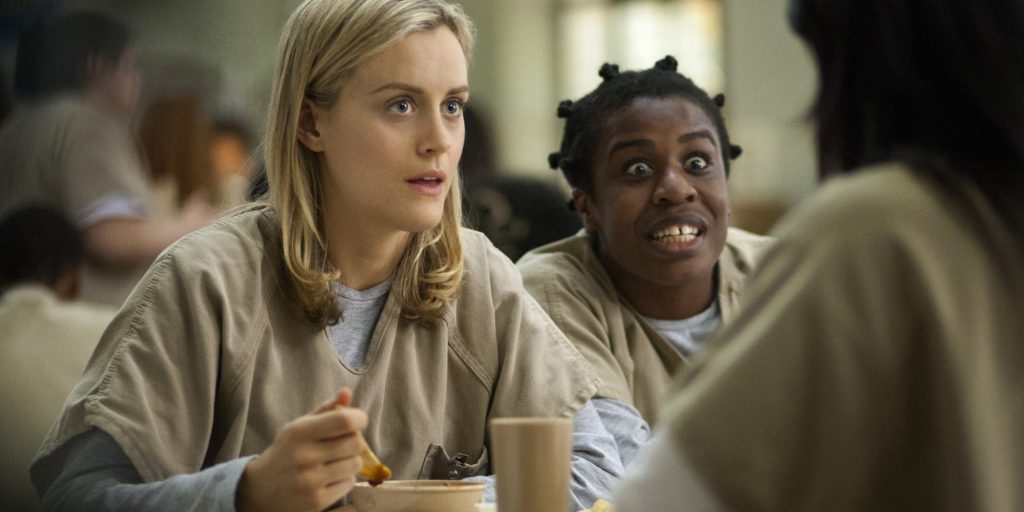 FILE - This image released by Netflix shows Taylor Schilling, left, and Uzo Aduba in a scene from "Orange Is the New Black." Season two debuts on Netflix on June 6, 2014. (AP Photo/Netflix, Paul Schiraldi, file)